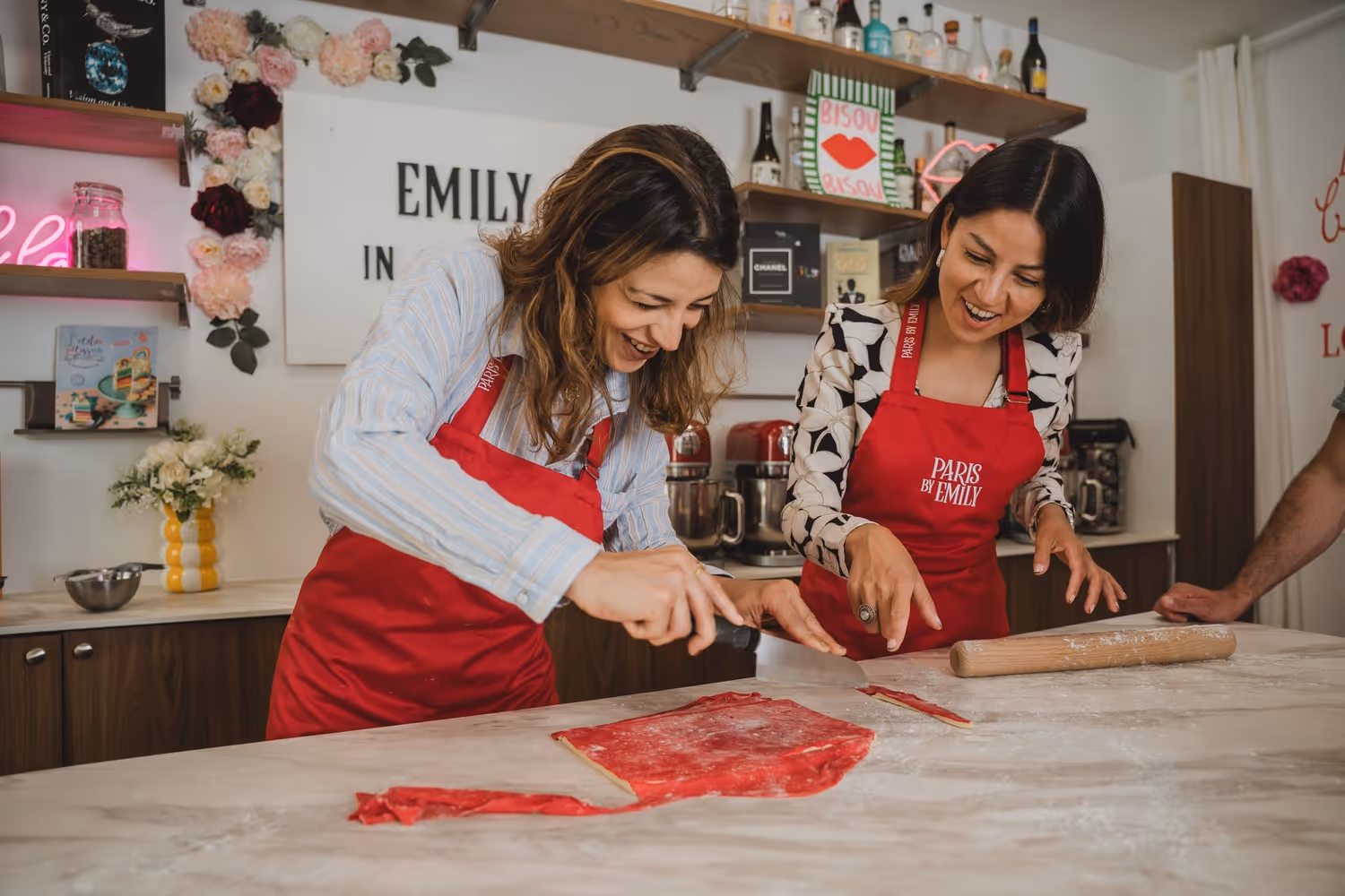 Croissant making two guests cutting the pastry and laughing